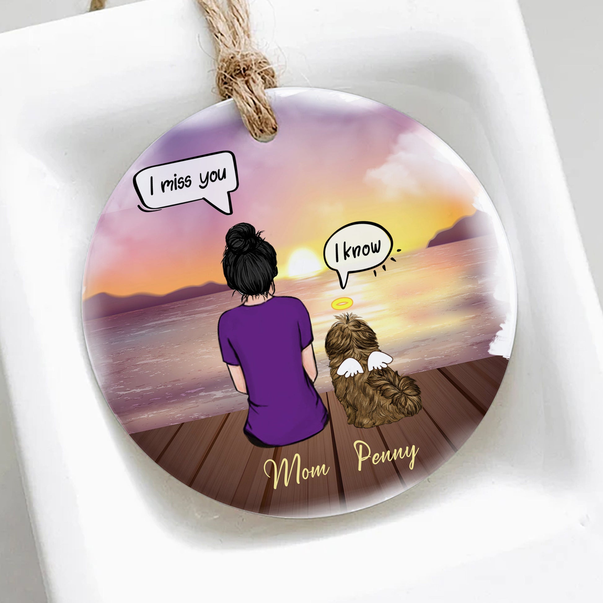 Round decorative item with a sunset scene of a woman and dog, featuring text 'I miss you' and 'I know'.