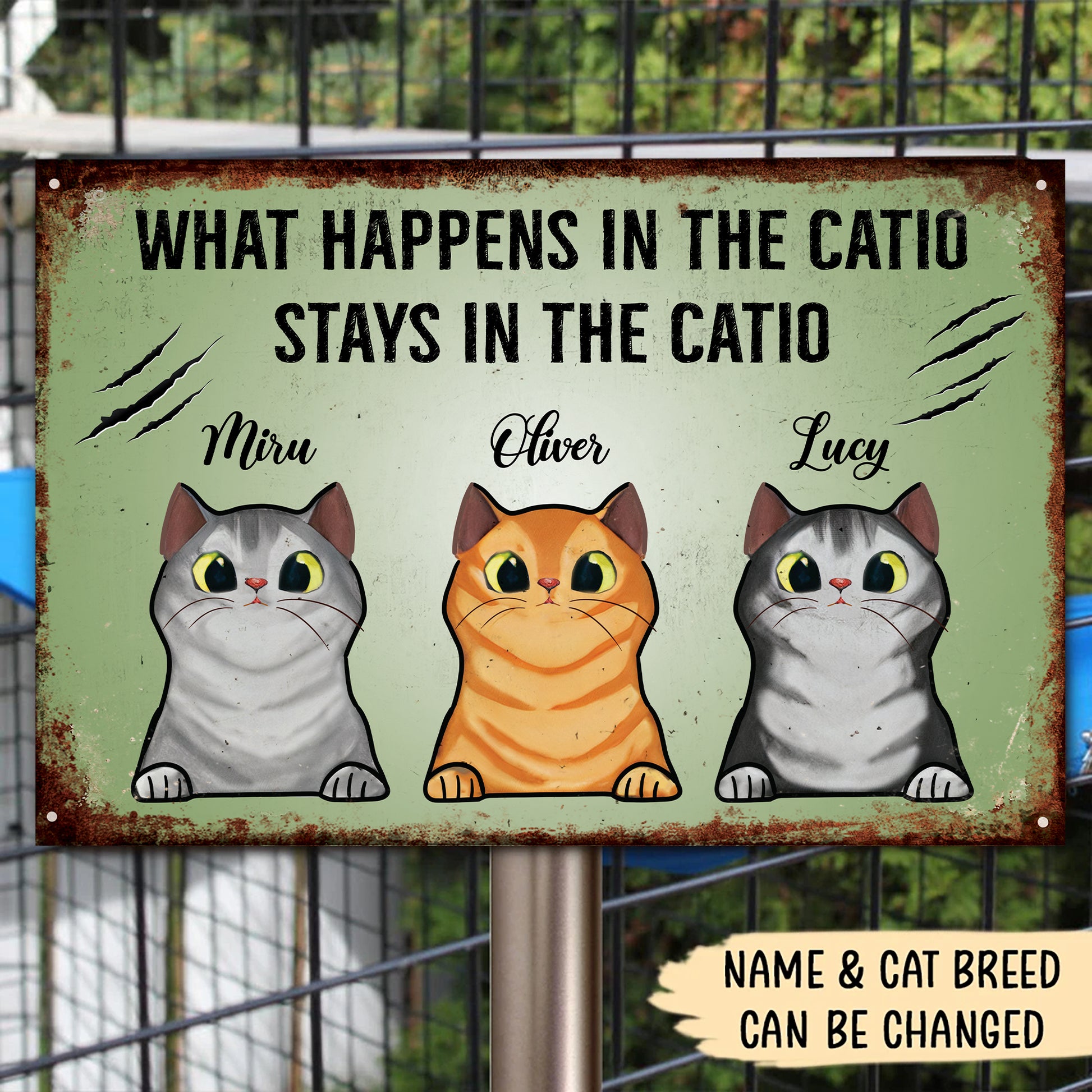 Metal sign with cartoon cats and text 'What happens in the catio stays in the catio' on a green background.
