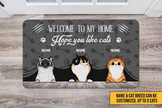 Personalized doormat with three cartoon cats and customizable text on a wooden floor.