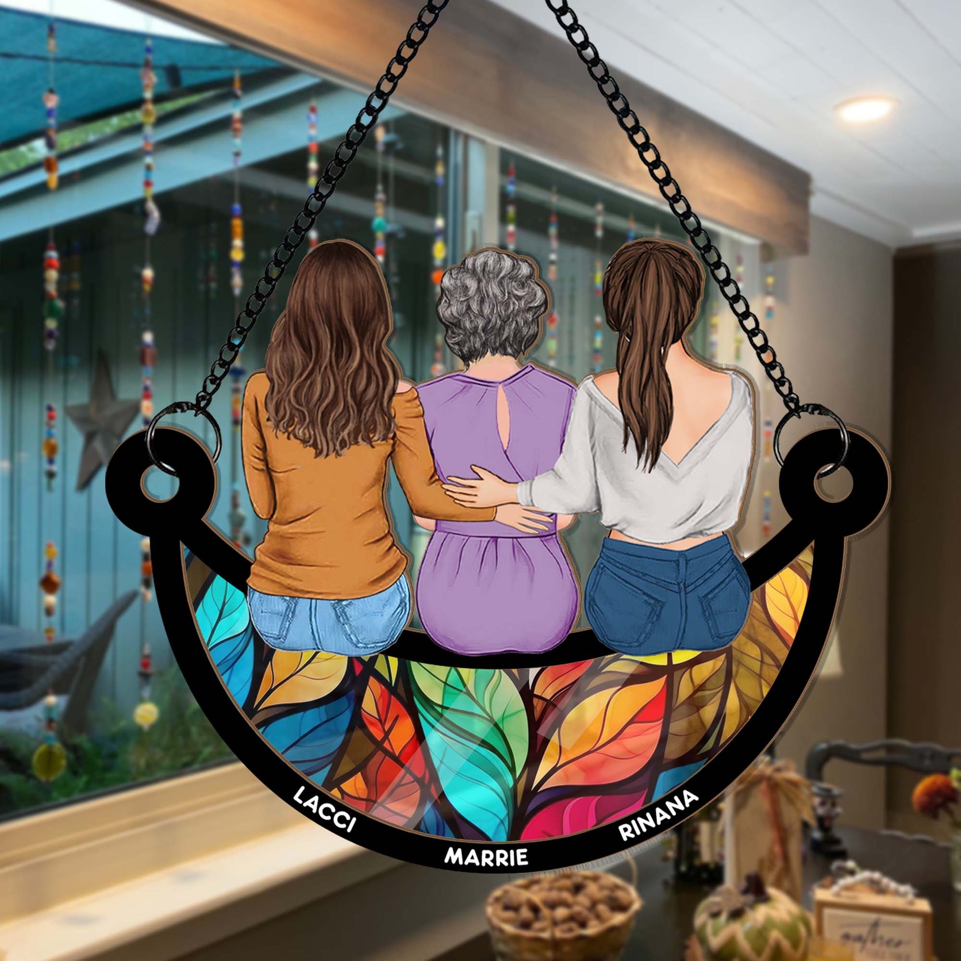 Decorative glass panel with three women hugging, featuring names LACCI, MARRIE, and RINANA, in a home setting.