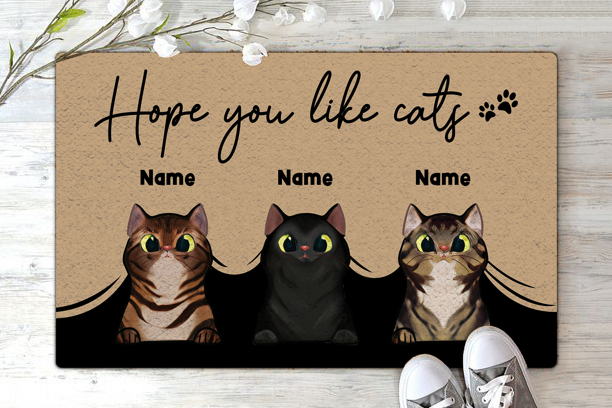 Doormat with cartoon cats and text 'Hope you like cats' on a wooden floor.