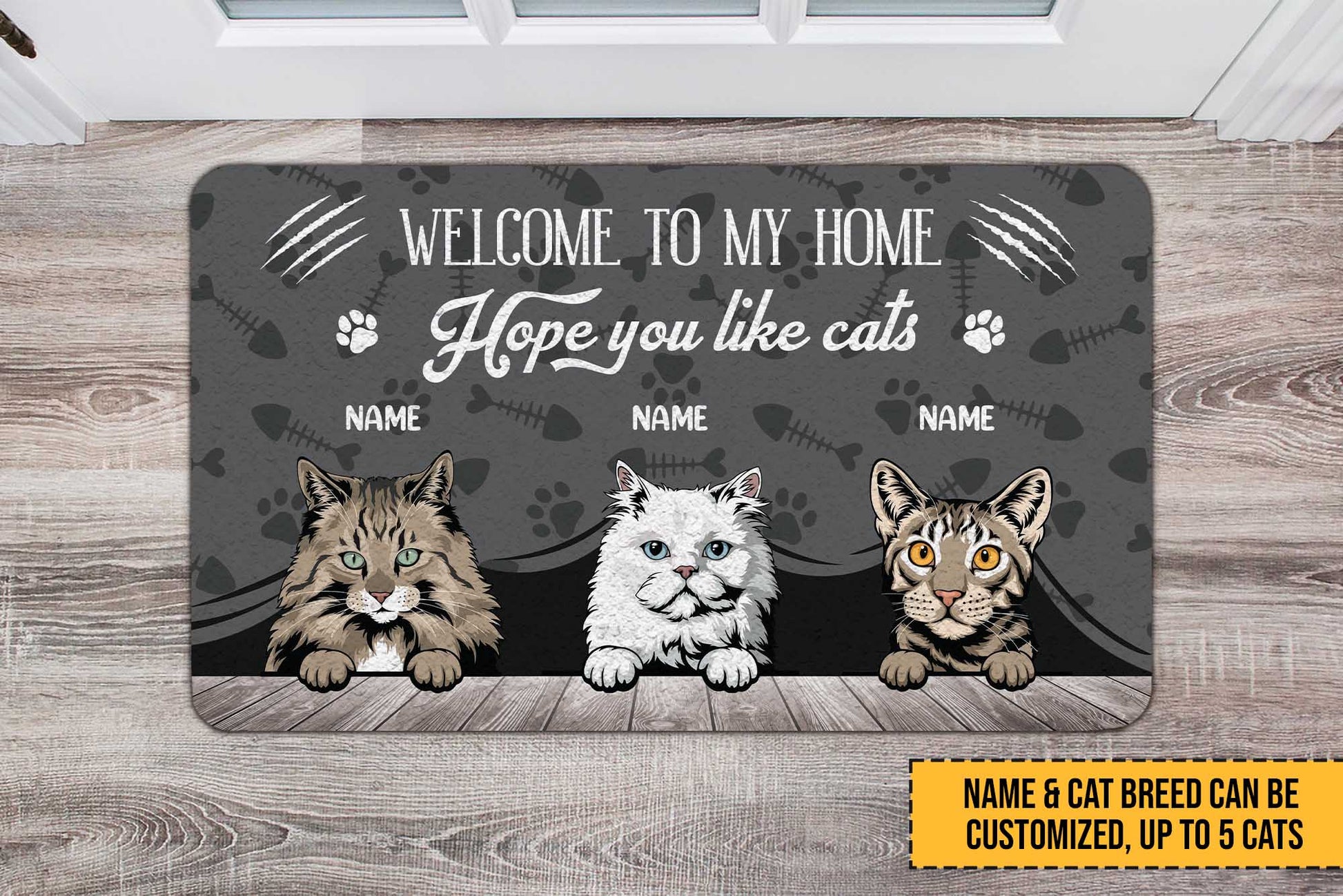 Personalized doormat with three cat illustrations and customizable text on a wooden floor.