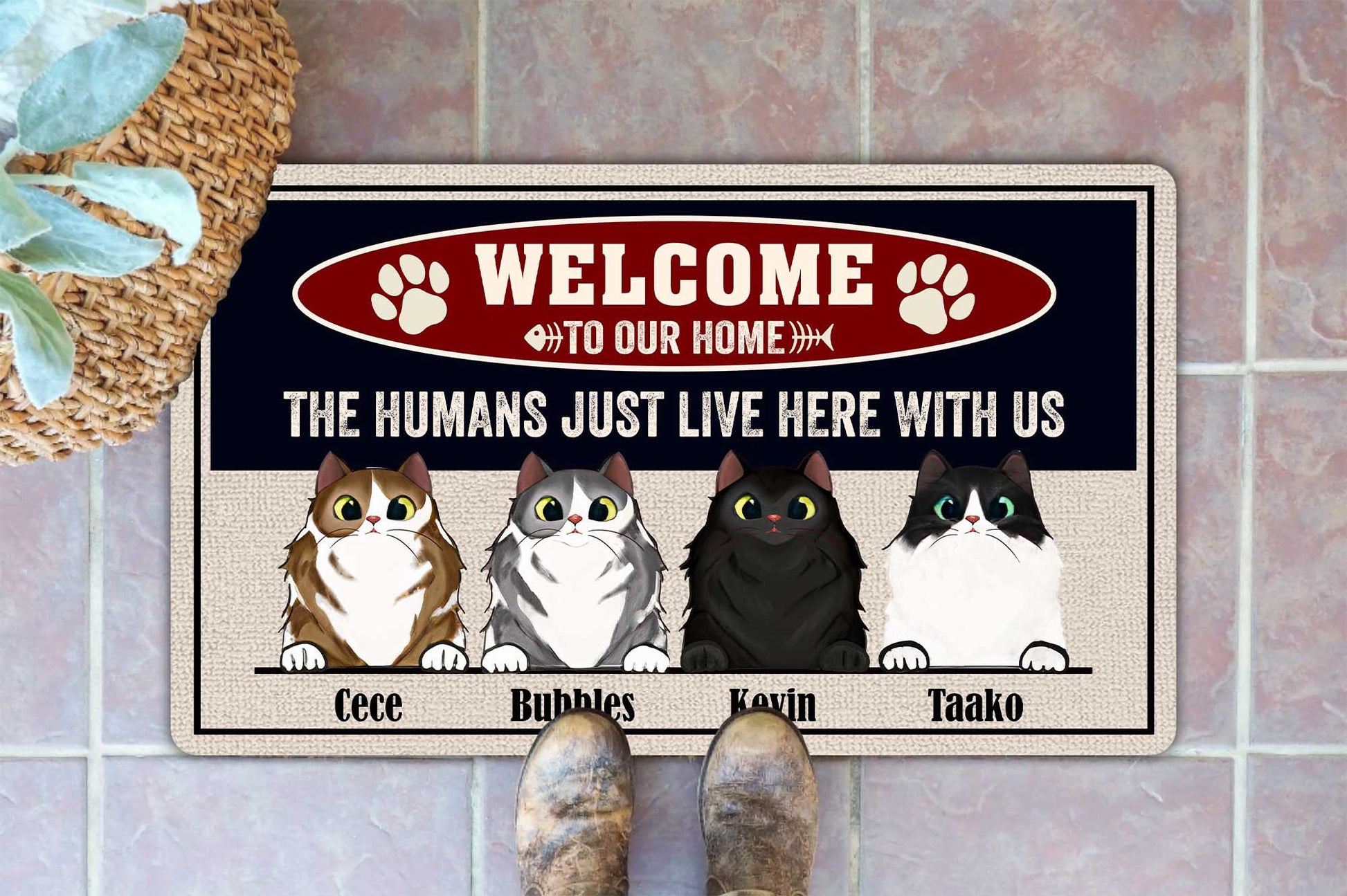 Doormat with cartoon cats and text on a tiled floor