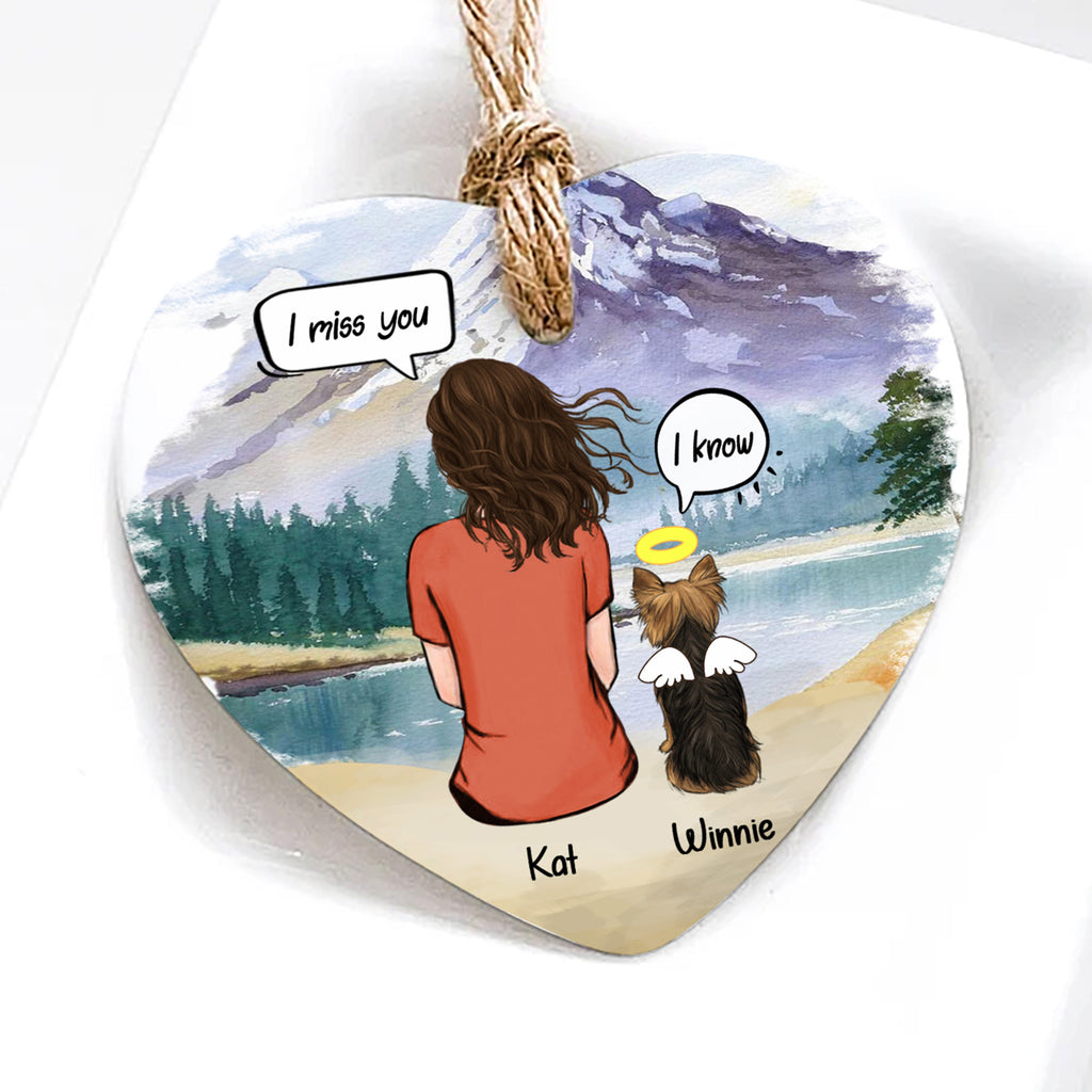 Heart-shaped ornament with illustration of a woman and her dog by a lake, with text bubbles and names.
