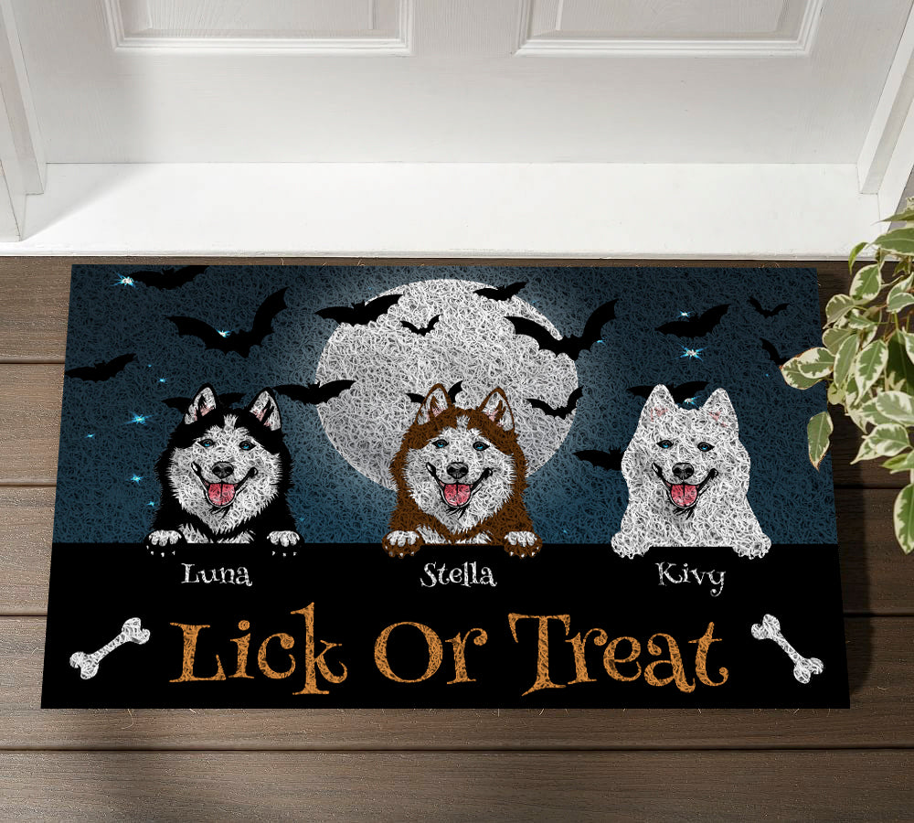 Halloween doormat with three dogs and 'Lick or Treat' text on a wooden floor.