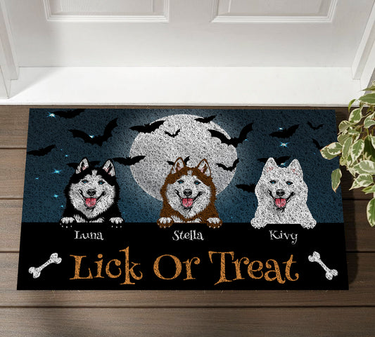 Halloween doormat with three dogs and 'Lick or Treat' text on a wooden floor.