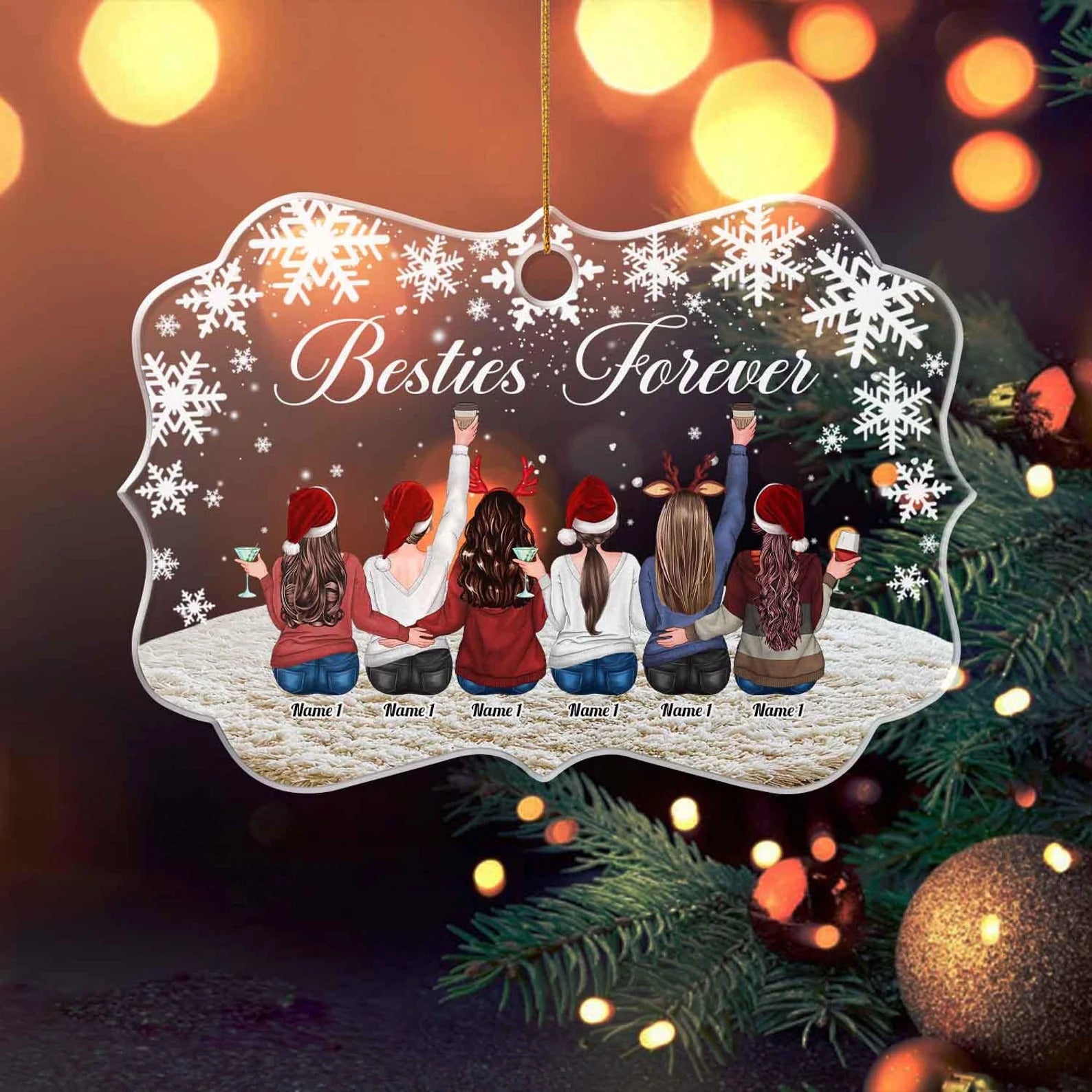 Decorative ornament with 'Besties Forever' text and images of friends in Santa hats against a snowy background, hanging on a Christmas tree.