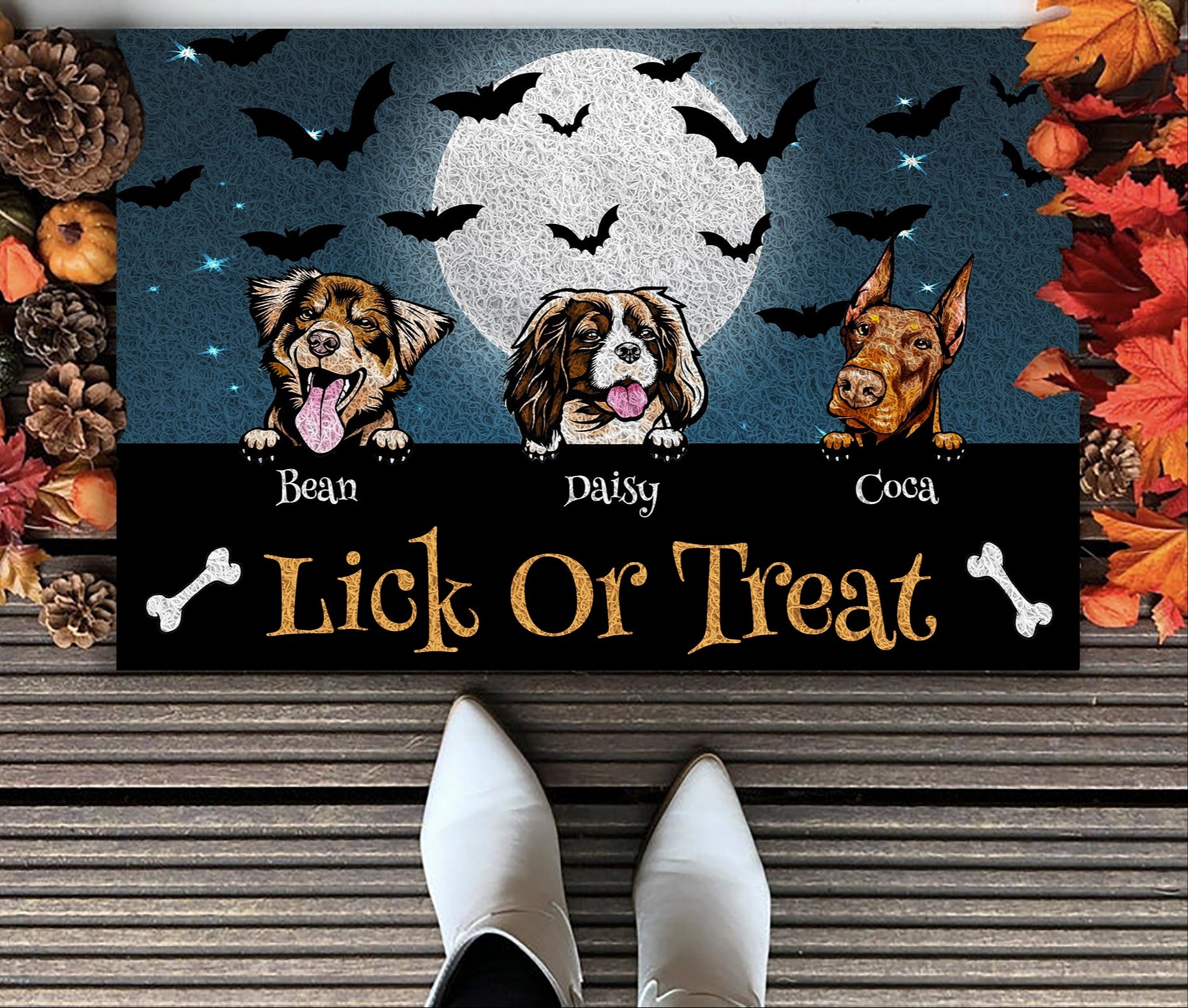 Halloween-themed doormat with three dogs and 'Lick or Treat' text, surrounded by autumn decorations.